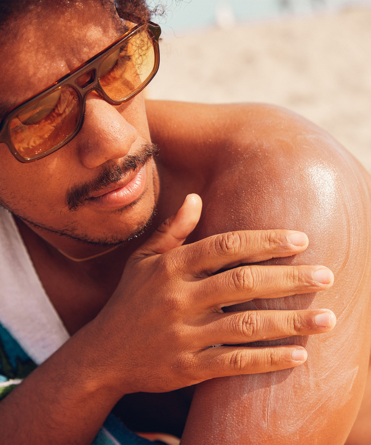 Man with sunglasses and sun-kissed skin outdoors