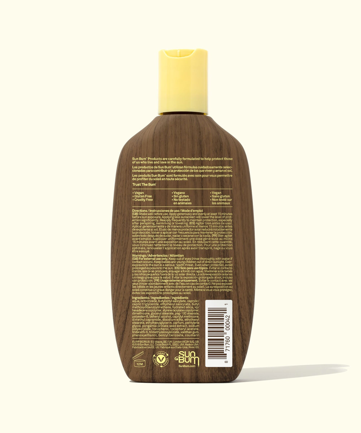 Back of a brown bottle with a yellow cap on a white background