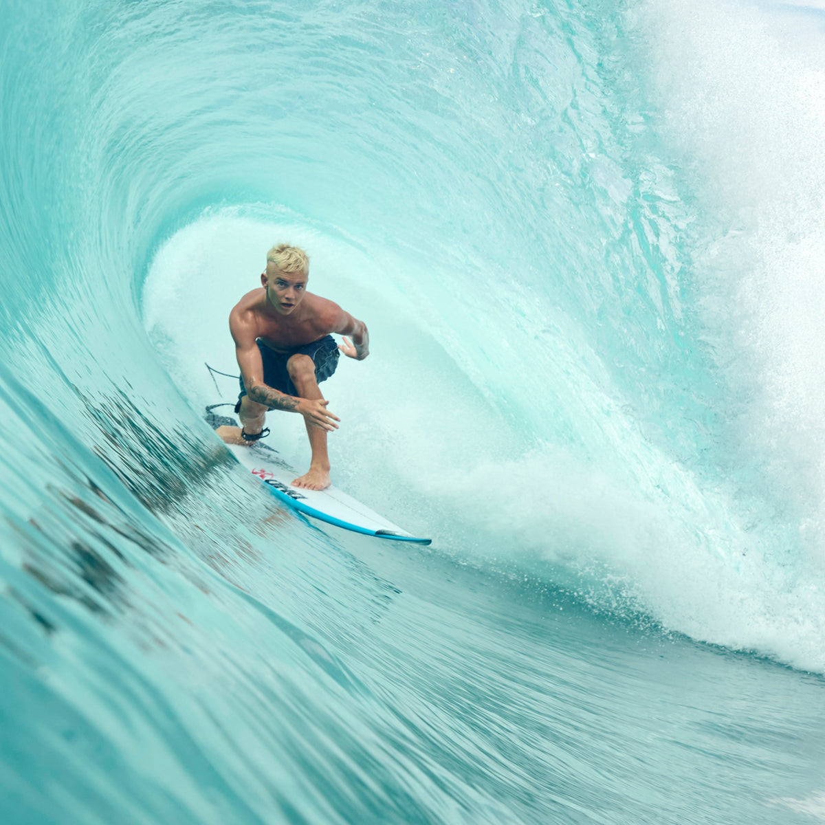 Surfer riding a wave in a tube